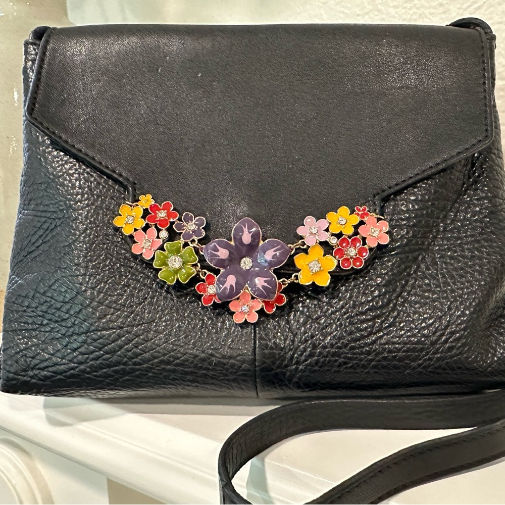 See By Chloe Black leather purse with enameled floral embellishment.